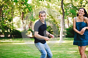 Guy and girl compete in the ring toss.