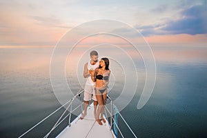 Guy with girl drink champagne on the ship.