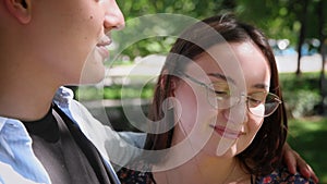 A guy and a girl eat ice cream in a city park