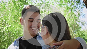 A guy and a girl eat ice cream in a city park