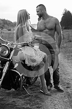 The guy with the girl in a field on a motorcycle