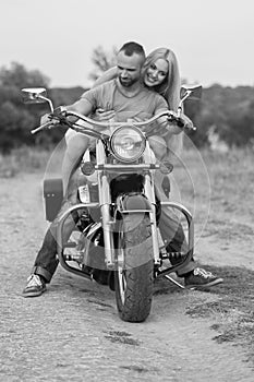 The guy with the girl in a field on a motorcycle