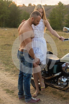 The guy with the girl in a field on a motorcycle