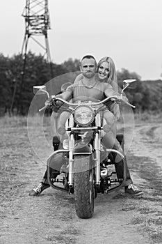 The guy with the girl in a field on a motorcycle