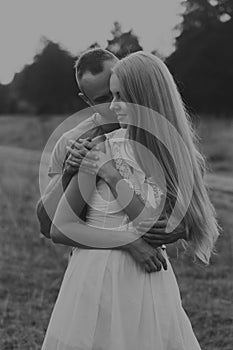 The guy with the girl in a field on a motorcycle