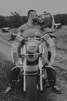 The guy with the girl in a field on a motorcycle