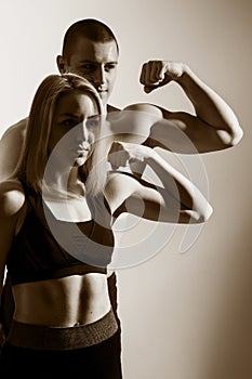 Guy and girl flex biceps. photo