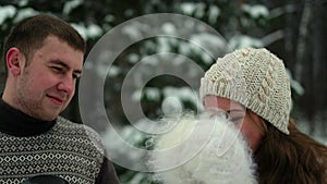 Guy and girl in the forest, drinking tea in winter