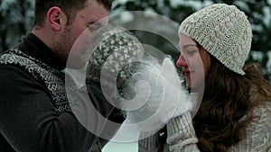 Guy and girl in the forest, drinking tea in winter