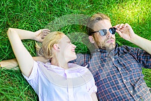 Guy and girl happy carefree enjoy freshness of grass. Closer to nature. Couple in love relaxing lay at meadow. Nature