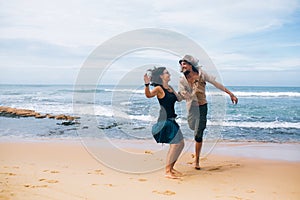 Guy and girl have fun on the beach