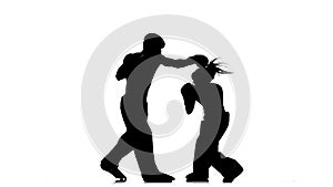 Guy with a girl in helmets and boxing gloves beating in the ring . Silhouette. White background