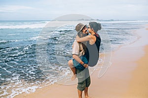 A guy and a girl are kissing on a beach