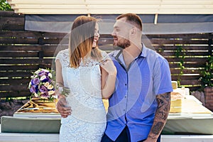 guy and girl look at each other, portrait of a romantic couple,man and woman kissing in a dramatic light, girl holding flowers in