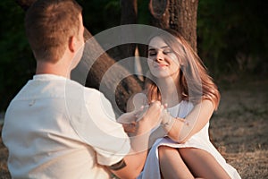 The guy and the girl are looking at each other.