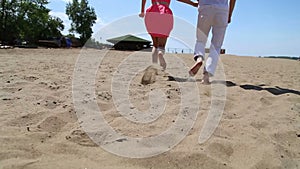 Guy and girl running around on the sand