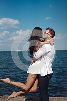 Guy and girl on the sea pier