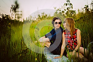 Guy and the girl sitting in the grass