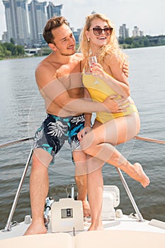 A guy with a girl is sitting on the stern of a yacht