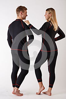 Guy and girl in thermal underwear on a white background