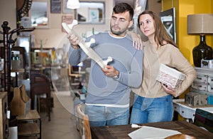 Guy with girlfriend buying wall hanger