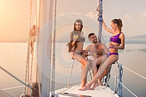 Guy with girls on yacht.