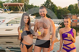 Guy with girls at the yacht club.