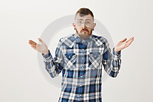 Guy give up and refuse dating after breakup. Portrait of miserable messy adult brother in blue plaid shirt and glasses