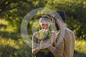 guy gives flowers to his girlfriend