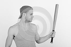 Guy in grey tank top holds bright green bat. Player with serious face plays baseball. Sports and baseball training