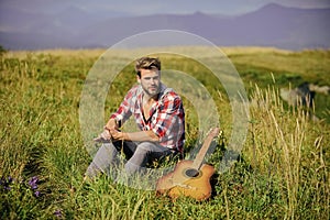 Guy with guitar contemplate nature. Inspiring nature. Pleasant time alone. Musician looking for inspiration. Dreamy