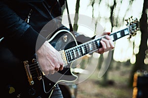 Guy with a guitar virtuoso plays photo