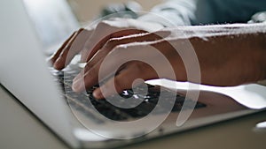 Guy hands typing keyboard laptop at apartment closeup. Man arms pressing buttons