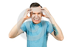 Guy has a headache, migraine dressed in a blue t shirt on a isolated white background