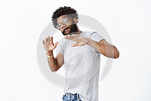 Guy having good vibes dancing and listening rap waving hands in rhythm of music licking lip and tilting head looking at