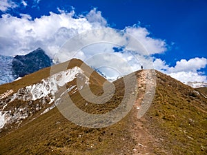 Guy hiking towards Upper Kyanjin Ri peak 4800 m. in Langtang National Park, Nepal