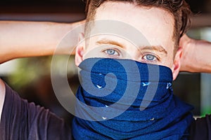Guy with his face half covered with scarf