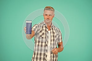 Guy hold bottle of mens bodywash blue background copy space, bodycare