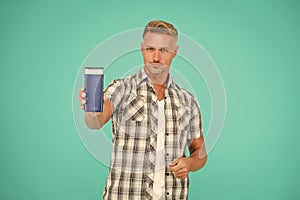 Guy hold bottle of mens bodywash blue background copy space, bodycare