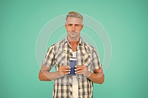 Guy hold bottle of mens bodywash blue background copy space, care