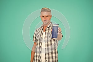 Guy hold bottle of mens shower gel blue background copy space, bodywash