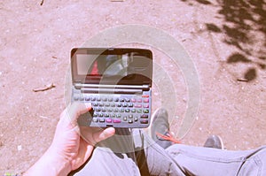 The guy is holding an old microcomputer. The obsolete device. photo