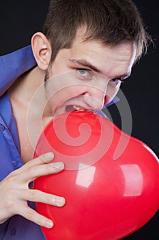 guy holding a red heart-shaped balloon