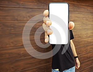 Guy holds mobile phone with blank screen