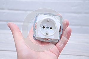 The guy holds a socket in his hand