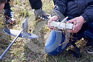 The guy holds the transmitter of the radio-controlled model of rocket plane