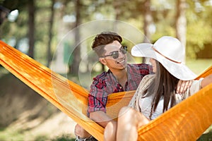 Guy hugging girl in hammock