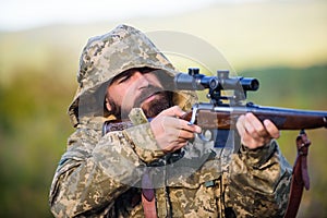 Guy hunting nature environment. Bearded hunter rifle nature background. Experience and practice lends success hunting