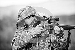 Guy hunting nature environment. Bearded hunter rifle nature background. Experience and practice lends success hunting