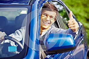 Guy inside car showing thumbs up